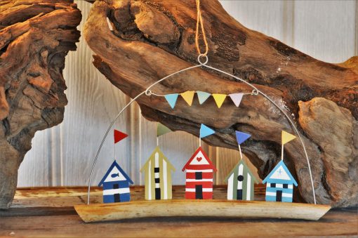 Five Coloured Beach Huts On Driftwood