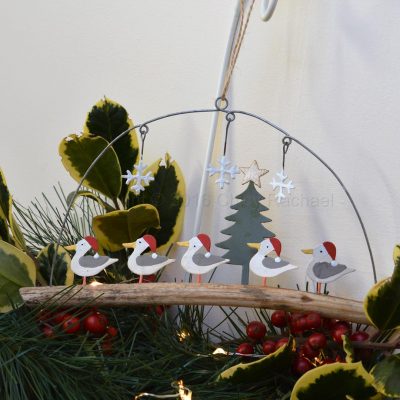 Seagulls In Christmas Hats On Driftwood